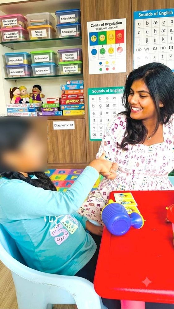 Therapist working with a child on language goals using flashcards